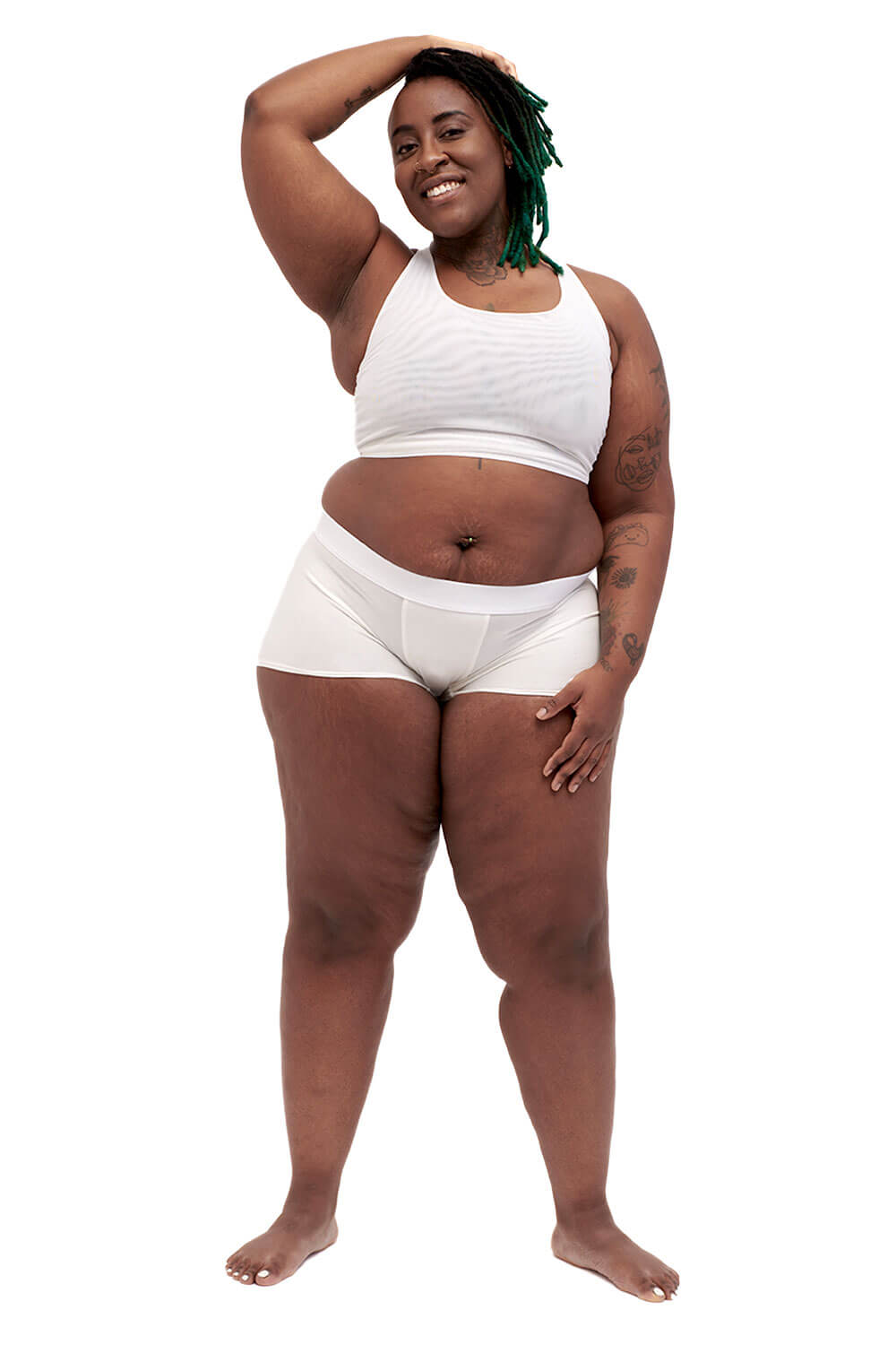 Plus-sized person wearing a white racerback chest binder made from breathable mesh, photographed from the front.