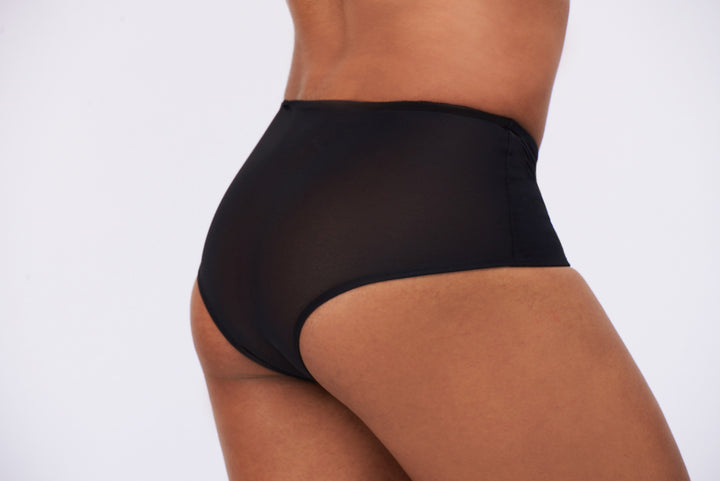 Detail of a mtf transgender compression gaff with a ckeey boyshort cut and sheer back, photographed from the side.